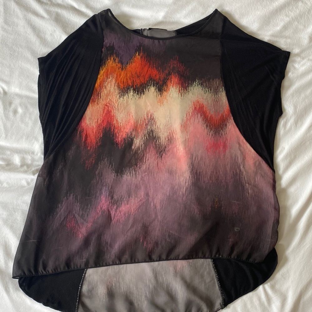 Beautiful blouse with translucent panels in the front and back. Light and airy.